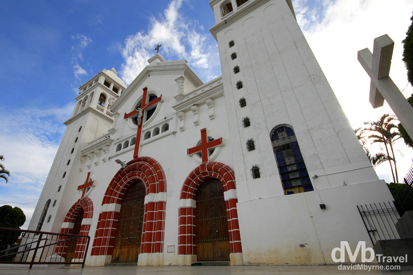 Juayúa's central plaza faces a gorgeous old white cathedral, known throughout El Salvador for featuring a black Christ statue that is on display behind the alter. The shady plaza it faces is perennially hosting elderly locals and is a nice place to just sit and contemplate some of life's great mysteries. Juayúa, Ruta de Las Flores, western El Salvador. May 29th 2013.  