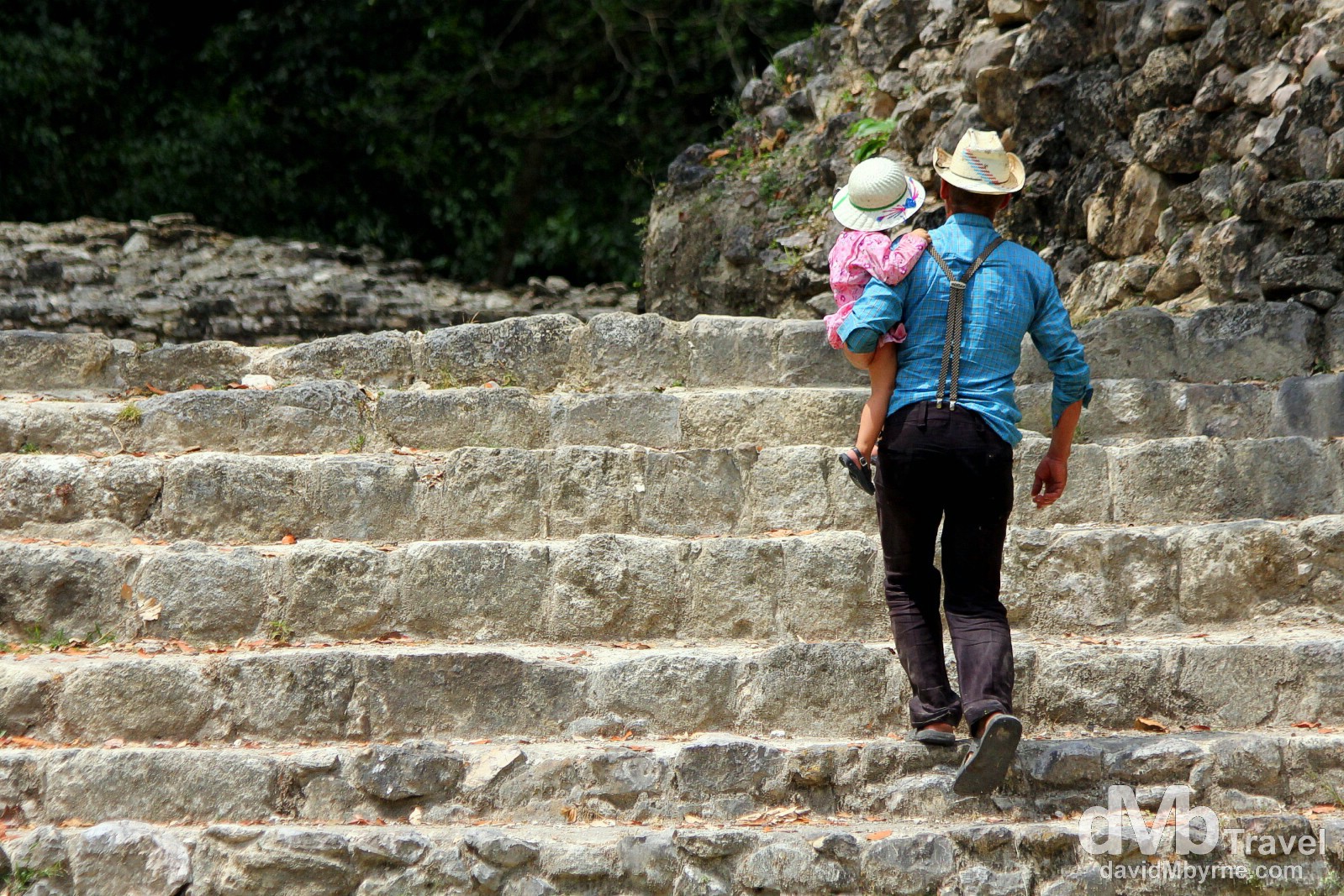 Ascending the steps of the Jaguar Temple at the Lamanai Mayan ruins in Central Belize. May 11th 2013.