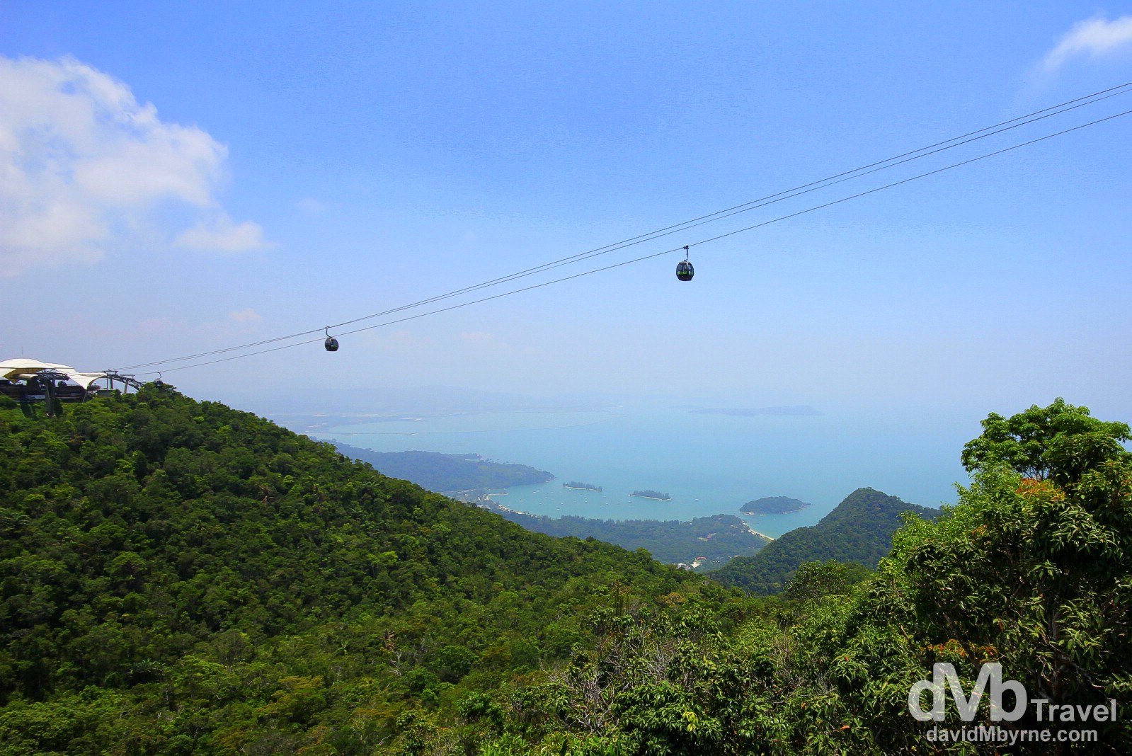 A shot of the west of Langkawi Island from the Top Station of the Langkawi Cable Car. The Cable Car, which opened in 2003, is 2.2km long, spans a section of the island’s Machincang mountain range & has 3 stations: Base, Middle (seen to the left, 650m above sea level) & Top (708m above sea level), above which is a viewing platform from where I took this picture. The visibility on this day was very poor - I had to crank the saturation in this & the next picture to show any kind of detail of the surrounding jungle-clad landscape & distant seascape. Gunung Machinchang, Langkawi Island, Malaysia. March 22nd 2012.