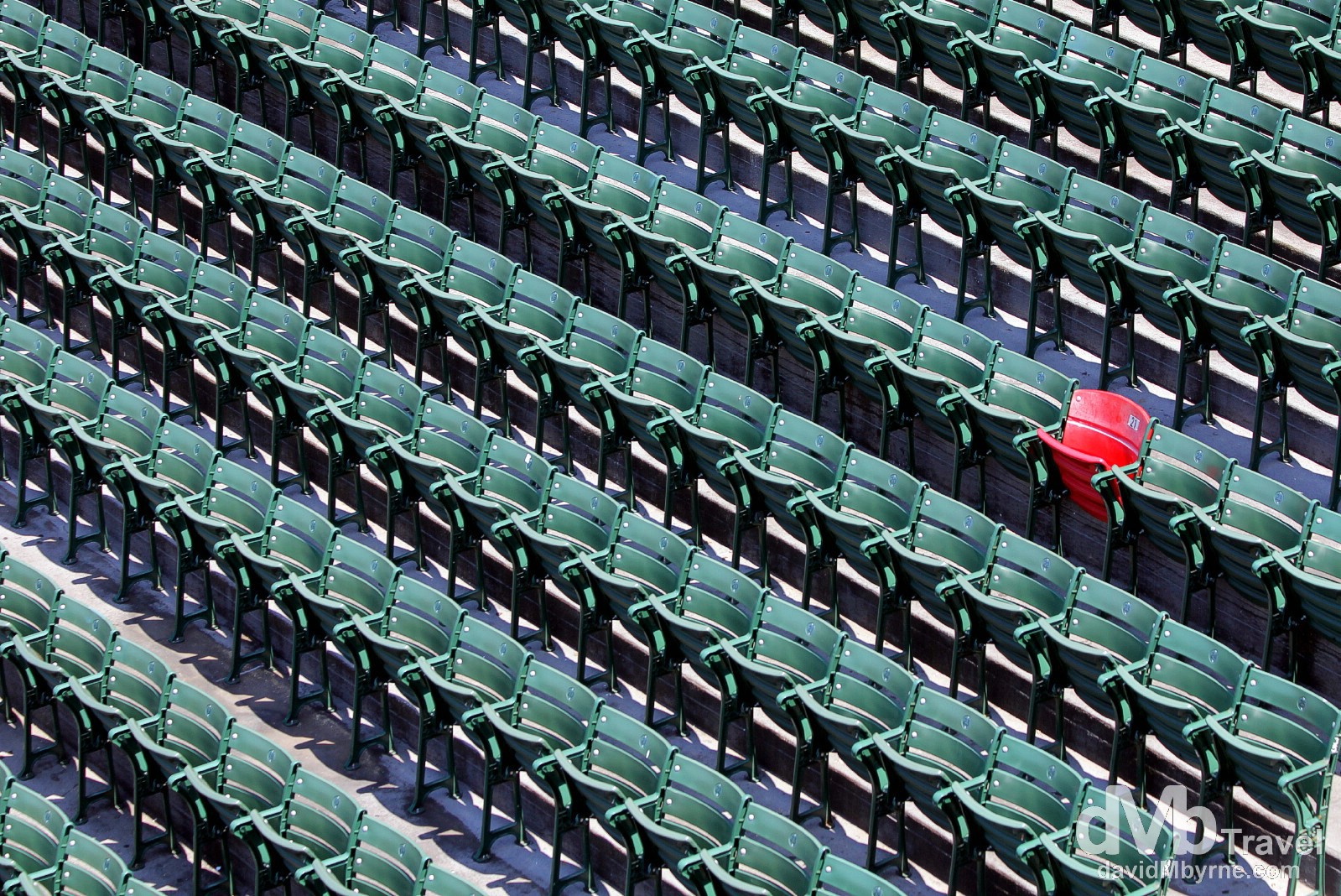 The Ted Williams red seat stands out amongst a see of green in the right field bleacher section of Fenway Park. Many baseball greats have played for the Red Sox, among them Babe Ruth, Carl Yastrzemski, & Ted Williams. On June 9, 1946, Williams hit a 502-foot homerun, the longest ever hit into the Fenway bleachers. The seat, located in section 42, row 37, seat 21, was painted red, one of only 2 in Fenway, to commemorate Williams' titanic blast, although at the time of the home run the bleachers were real bleachers and not individual seats. Fenway Park, Fenway, Boston, Massachusetts, USA. July 17th 2013.