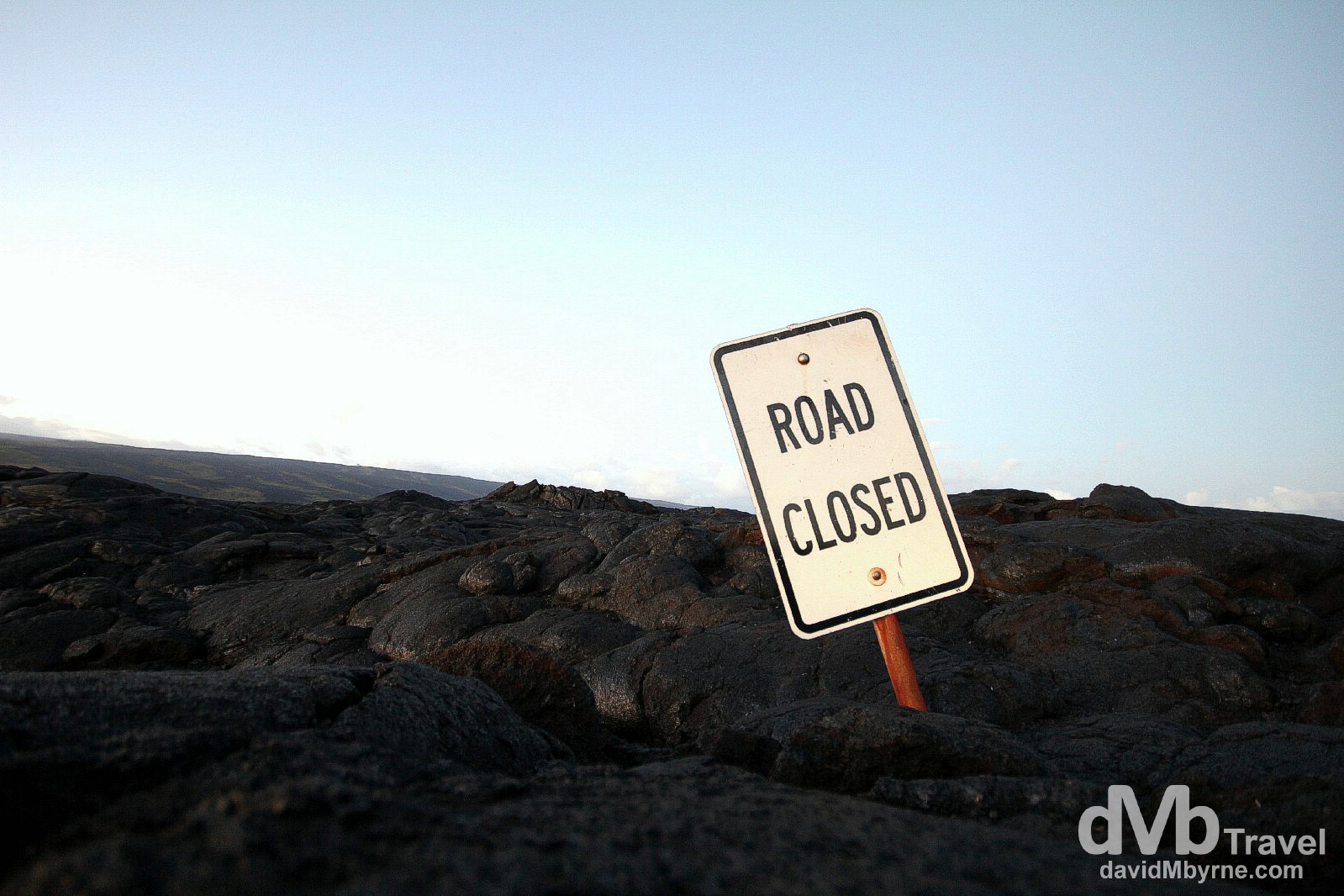 Road closed indeed. A single road sign is all that’s left of a road buried in lava on the south coast of The Big Island, Hawaii. March 1st 2013.