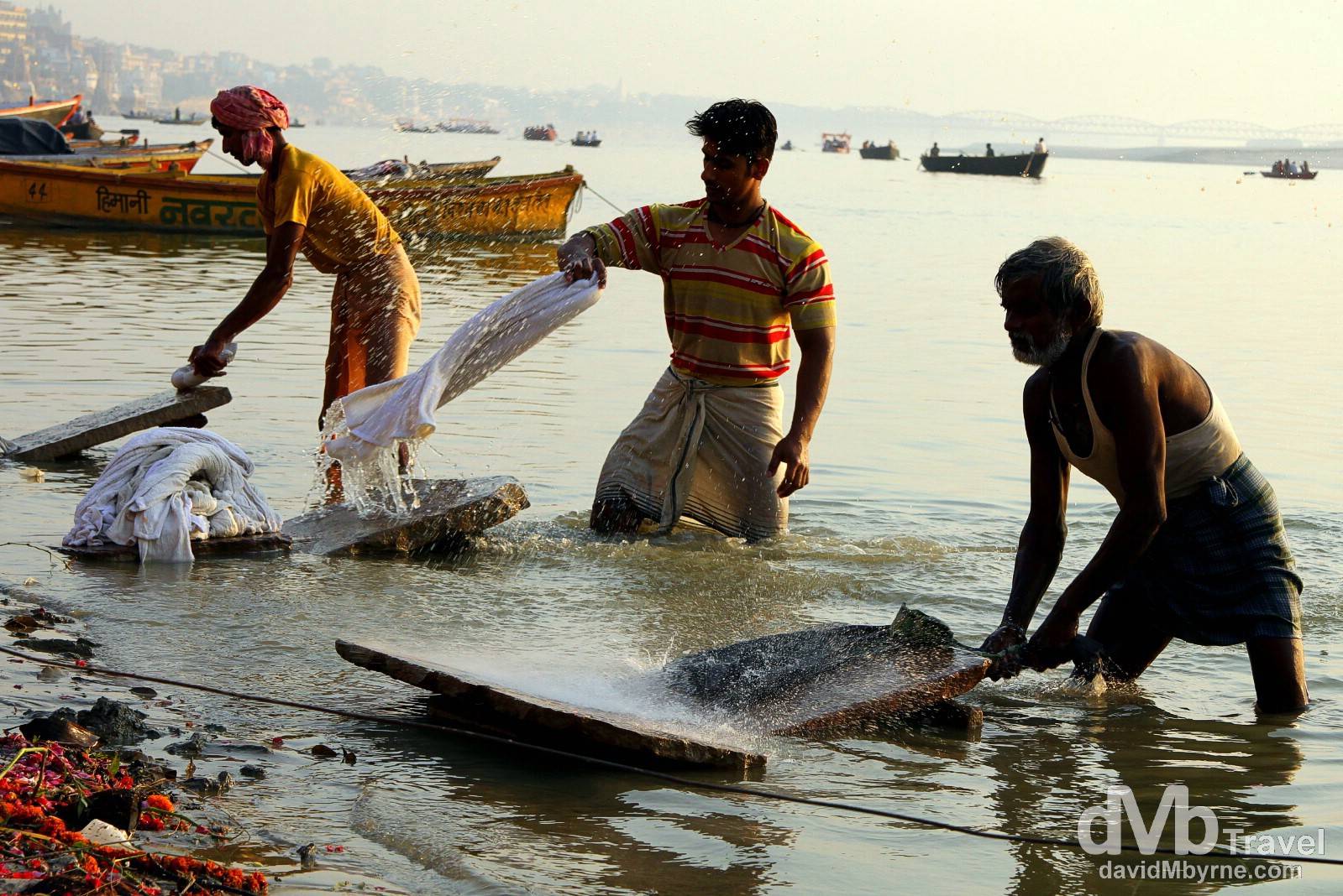 Dhobi Wallahs doing laundry on the edge of the River Ganges in Varanasi, Uttar Pradesh, India. October 13th 2012.