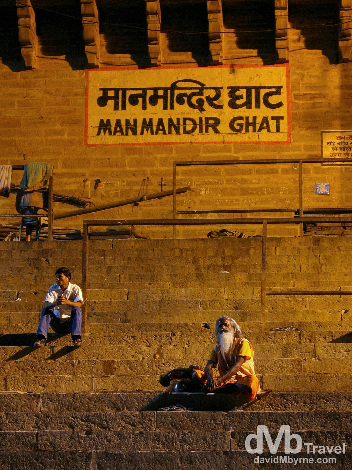 A Sadhu, a Hindu holy man on the path to enlightenment, and a local sitting at Manmandir Ghat, Varanasi, India. Ghats have been used in India for centuries, primarily for worship, but also for bathing and washing clothes. They are also used for the final ritual of cremation and some of Varanasi’s Ghats are solely used for this purpose. March 18th 2008.