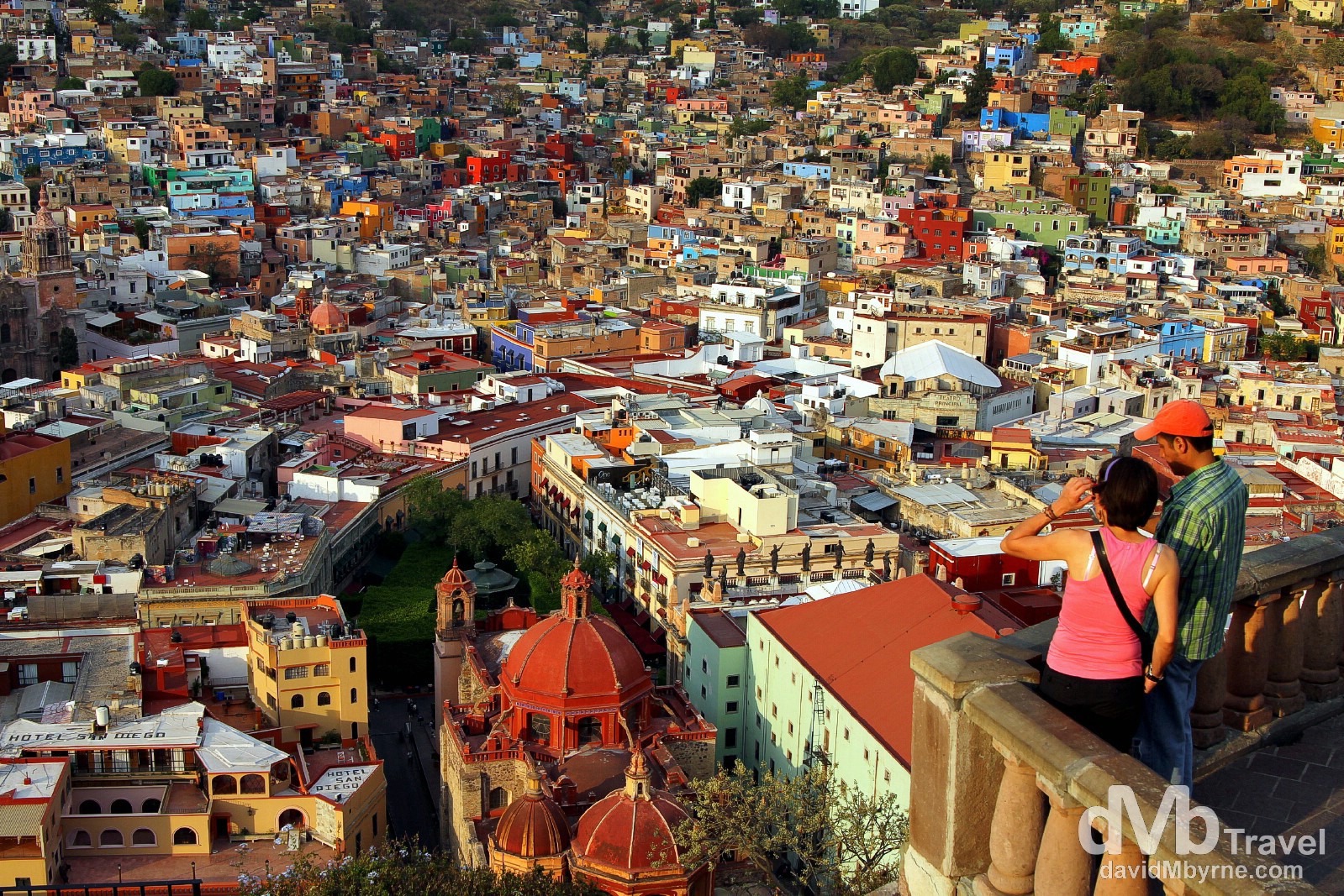 Overlooking UNESCO World Heritage listed Quanajuato as the sun sets from Panoromica. Riding the (very short) Funicular from behind Teatro Juarez to the top of San Miguel Hill is one of the must-do Guanajuato activities - you could of course walk up or, better still & as I did, get the funicular up and get lost in the jumble of photographic lanes by walking down (it's not far). This vantage point is visible from all over the city as it houses a 28-metre-tall statue, called El Pipila, of an independence hero who wore a stone slab on his back to protect himself while burning the Spanish troops holed up in the city's  Alhóndiga, or granary, in September 1810. The views here are spectacular, especially towards the end of the day when the light is at its softest. Guanajuato, Mexico. April 23rd 2013.