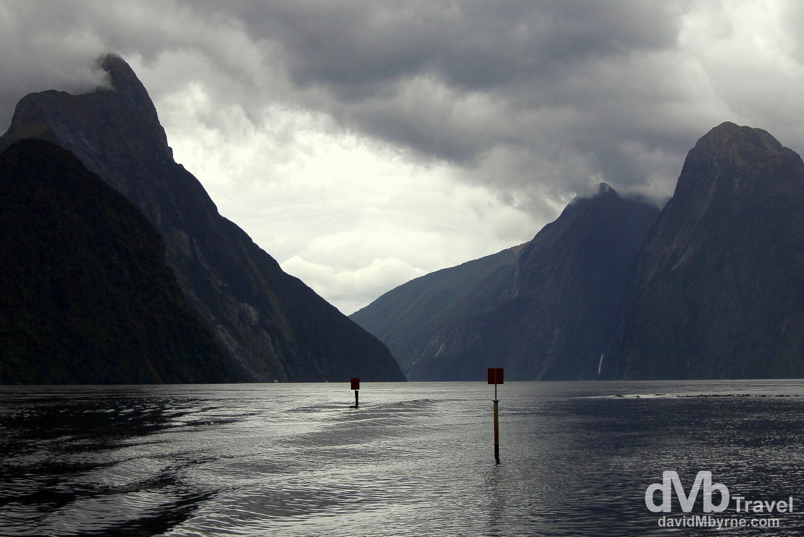 Cloud hovers over the peaks, including Mitre Peak (left), on a wet day in Milford Sound, South Island, New Zealand. May 26th 2012.