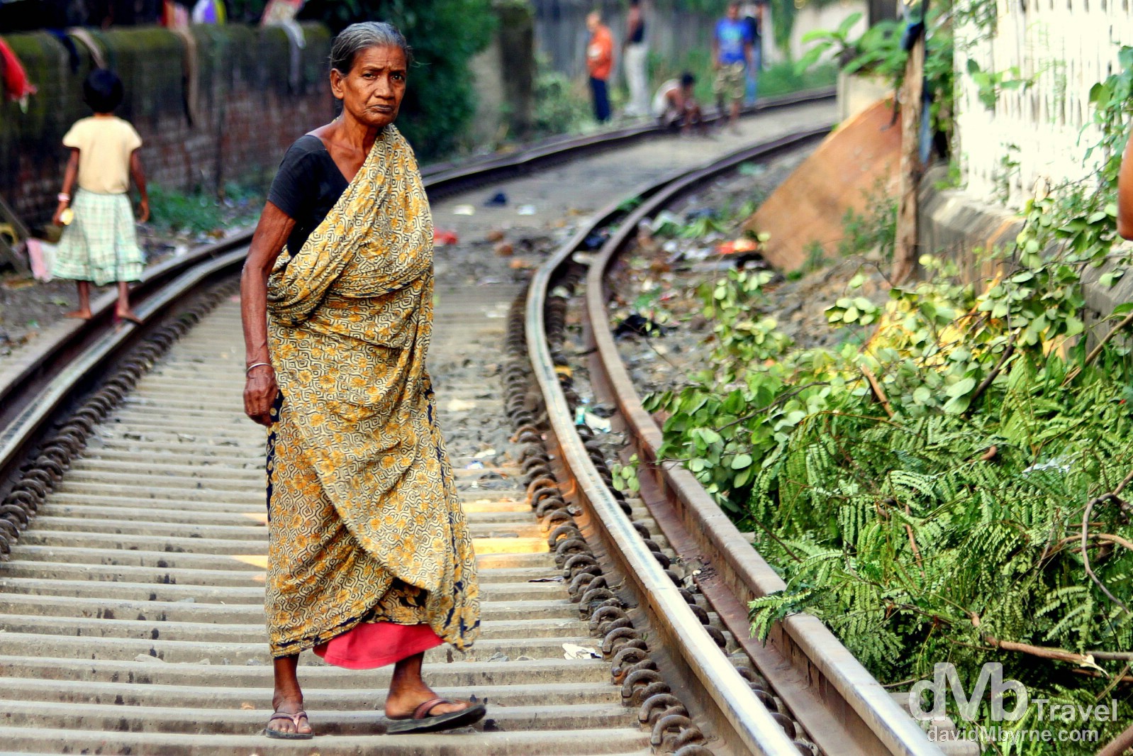 Crossing the train tracks near the Babu Ghat in Kolkata (Calcutta), West Bengal, India. October 15th 2012.