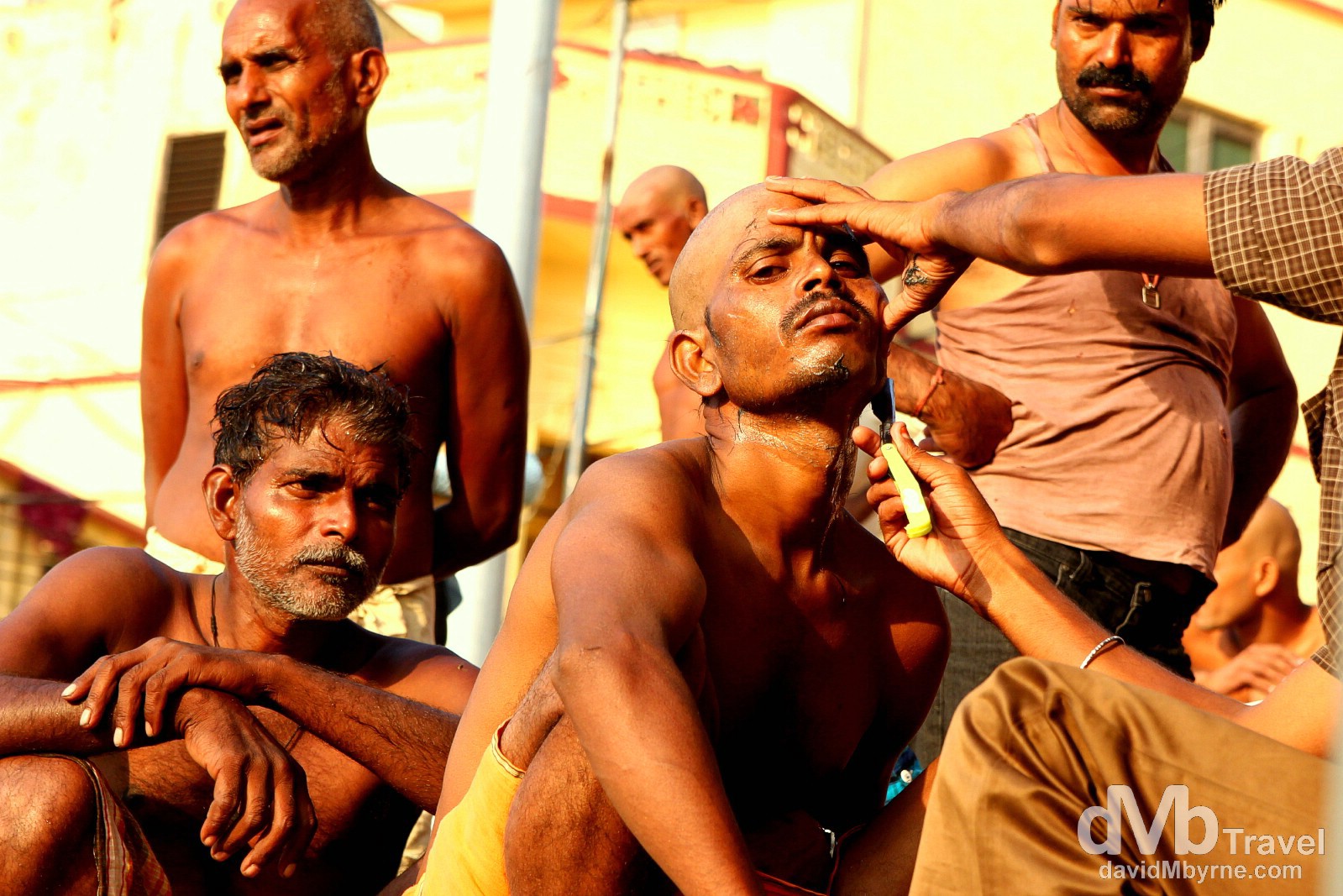 Getting a shave on the steps of a ghat by the Ganges River in Varanasi, Uttar Pradesh, India. October 13th 2012.