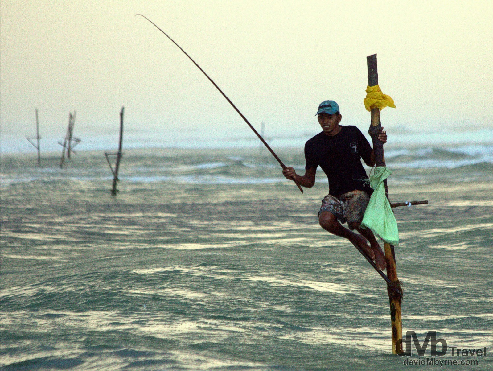 A stilt fisherman plying his craft outside the village of Koggala, southern Sri Lanka. September 2nd 2012.