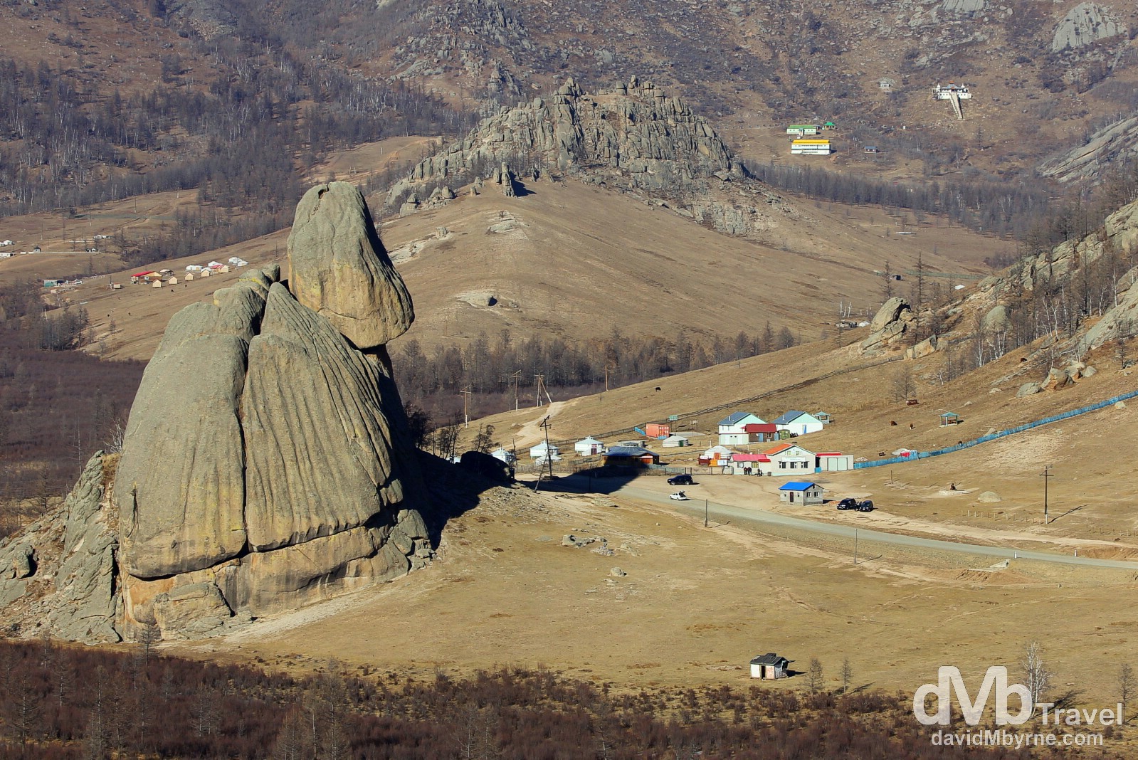 Turtle Rock overshadows a small settlement in Terelj National Park, Mongolia. November 3rd 2012.