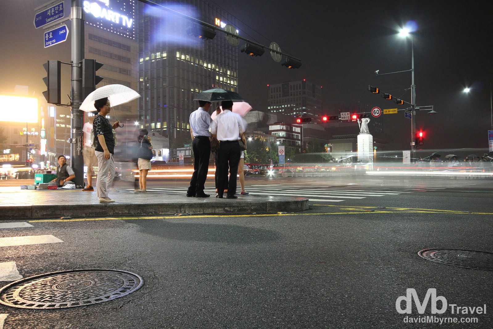 Waiting in the light rain at a traffic junction in Jongno, Seoul, South Korea. July 12th 2012.