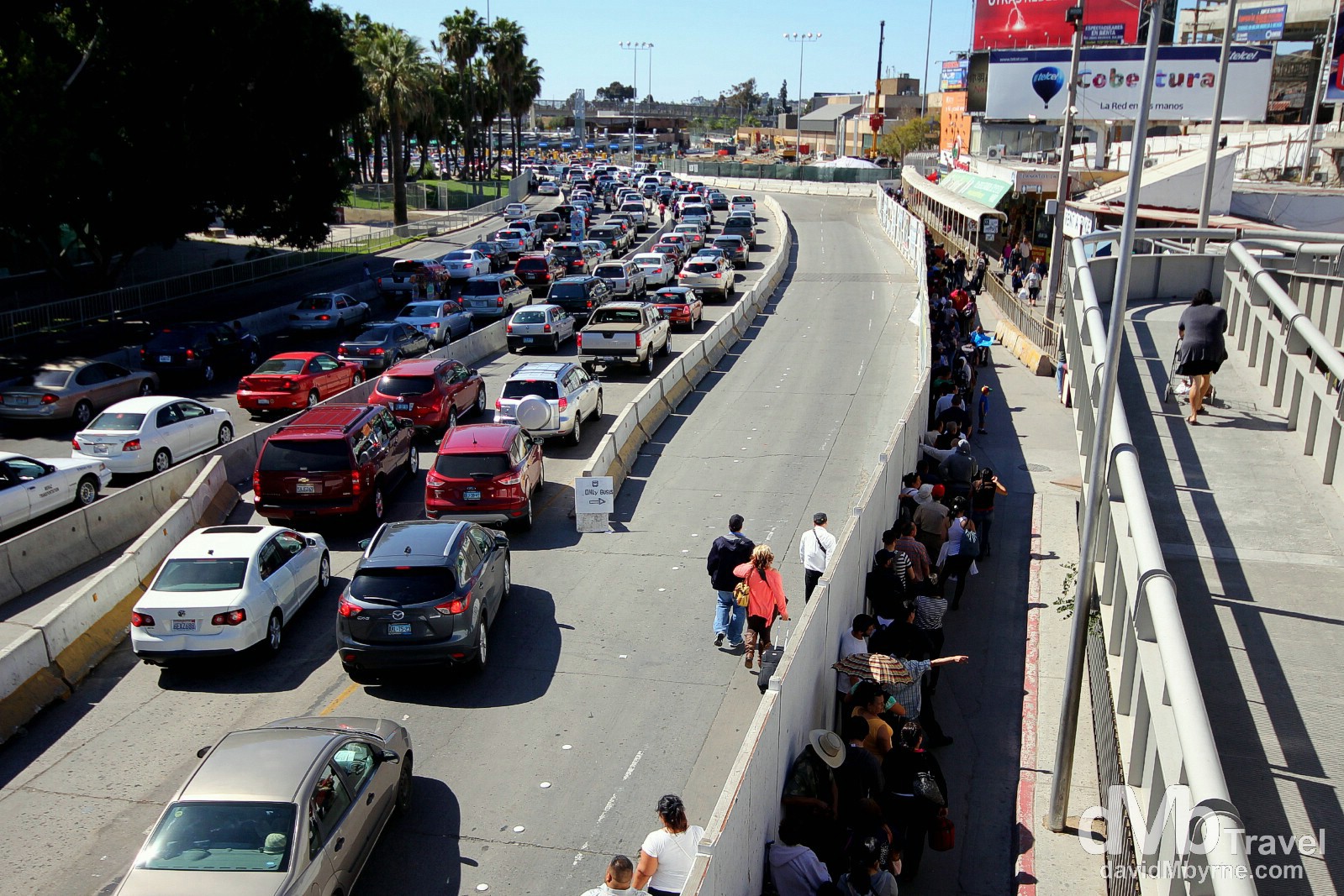 A picture taken on the short walk through/across the USA/Mexico border, having just crossed into Mexico. The cars & people seen here are queuing to get into the States (both lines stretched for quite a distance behind me also). No such queues in the other direction... and no officials either. Mexico/USA border crossing, Baja California, Mexico. April 18th 2013.