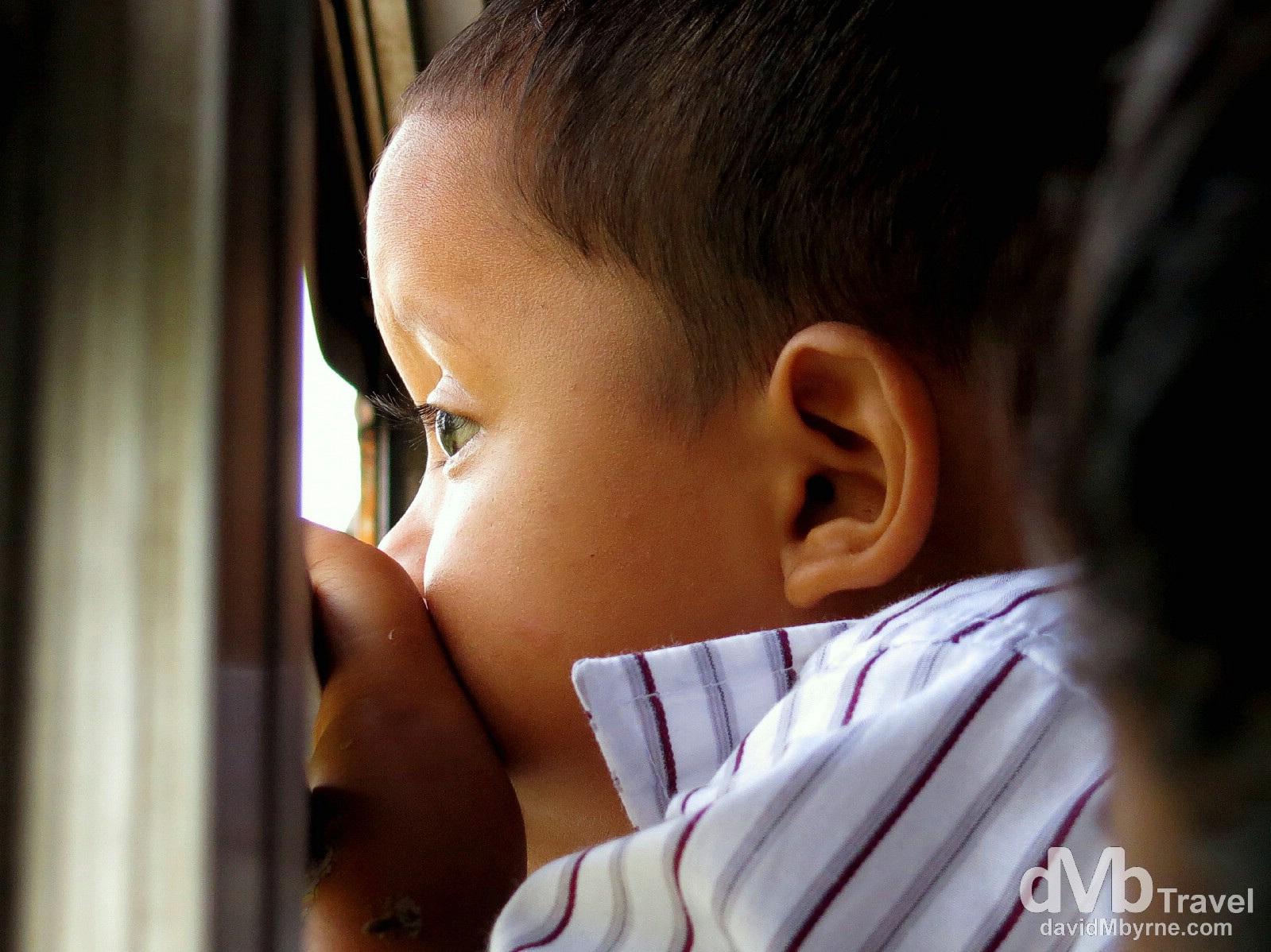 A boy looking out the window on the bus to the ferry terminal in Isla de la Ometepe, Lago de Nicaragua, Nicaragua. June 21st 2013.