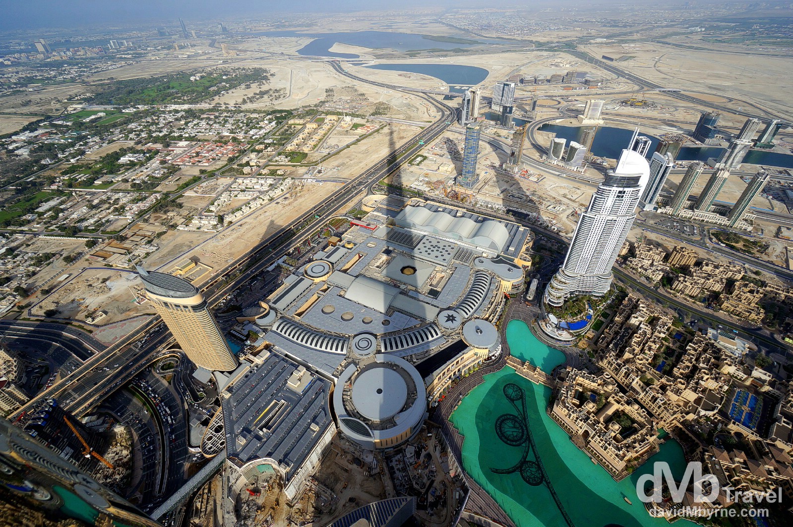 The 829.8 metre Burj Khalifa, the world's tallest building, casts a shadow over The Dubai Mall, the world's biggest & busiest shopping mall, as seen from At The Top, the 124th floor viewing deck. Dubai, UAE. April 18th, 2014. 