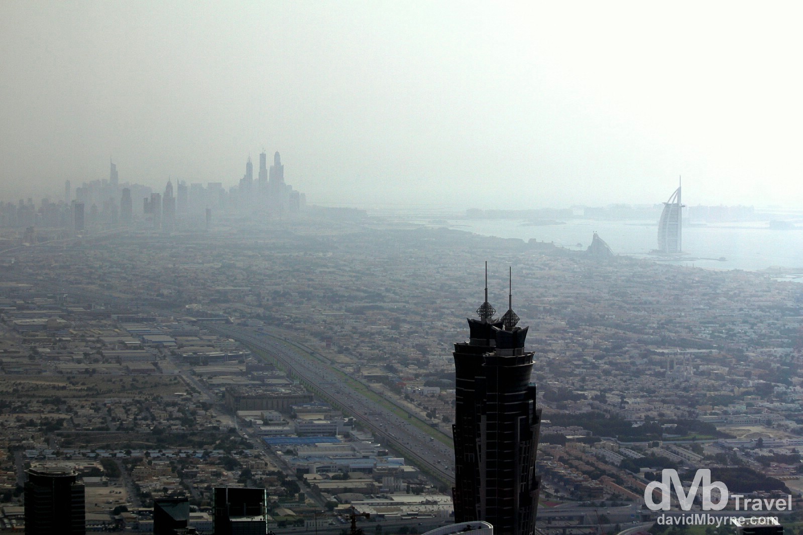 The distant towers of Dubai Marina, the man-made Palm Jumeirah island & the 7-star Burj Al Arab as seen from the At The Top, the 124th floor viewing deck of the Burj Khalifa, the world's tallest building. Dubai, UAE. April 18th, 2014.
