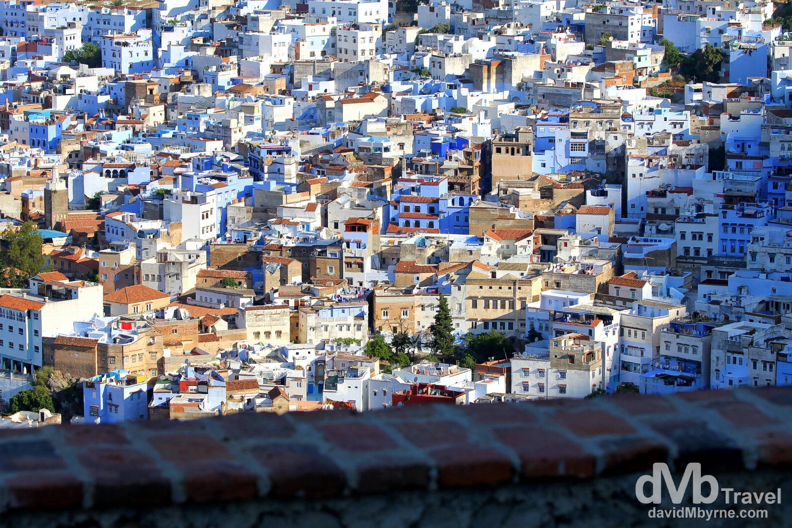 The rising sun creeps over a portion of the Chefchaouen Old Town as seen from the hills overlooking the town. Chefchaouen, Morocco. June 1st, 2014.