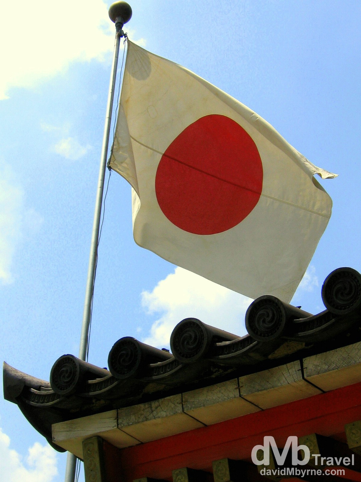 The Japanese flag flies over the entrance to the Yasaka Jinja Shrine in Kyoto, Honshu, Japan. July 18th, 2005.