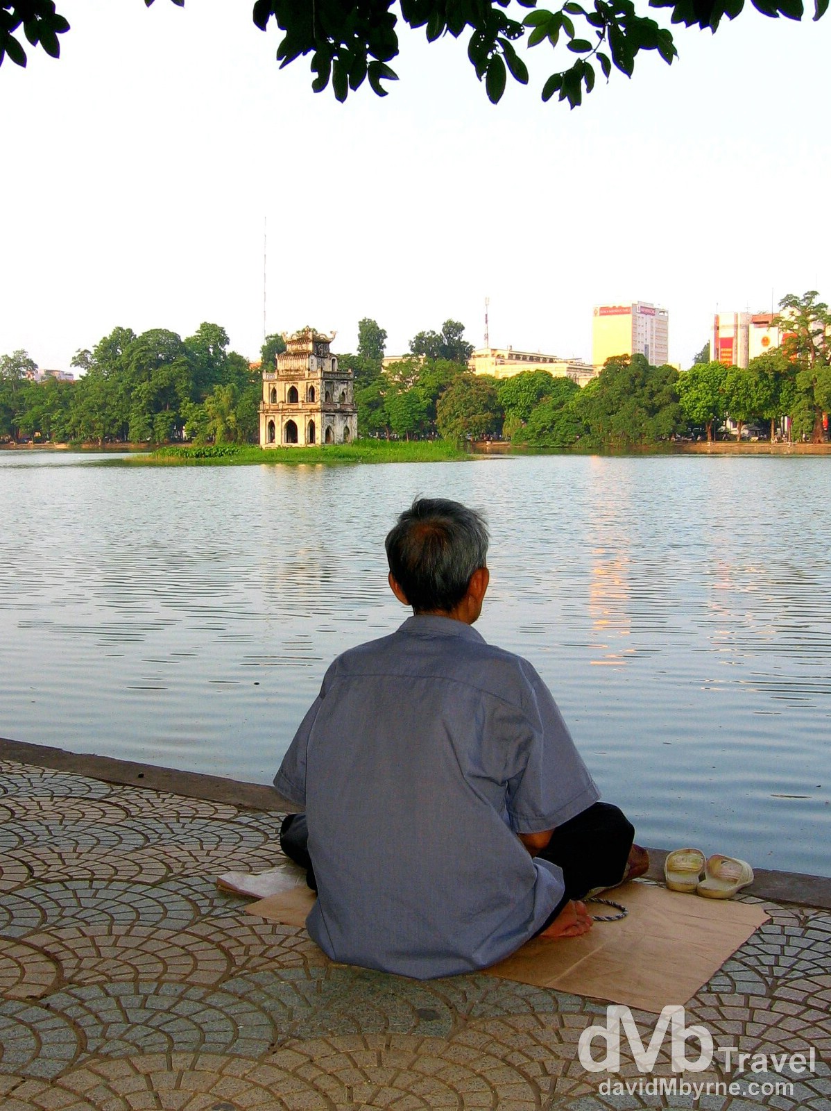 Sitting by the edge of Hoan Kiem Lake in Hanoi, Vietnam. September 5th, 2005.