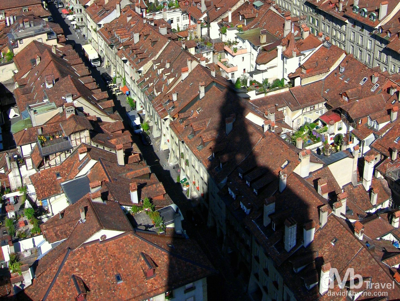 The spire of the late-Gothic Cathedral, or Münster, casts a shadow over the roofs of Old Town in Bern, Switzerland. August 24th, 2007.