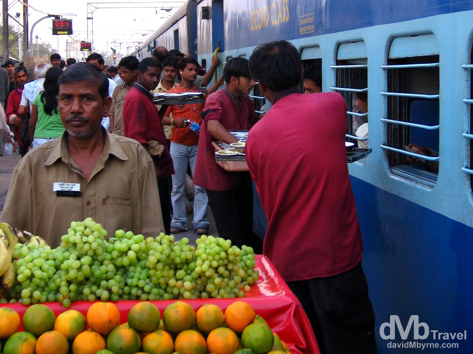 Vendors tending to the passengers on the Goa Express from the platform of Agra train station, India. March 26, 2008. 