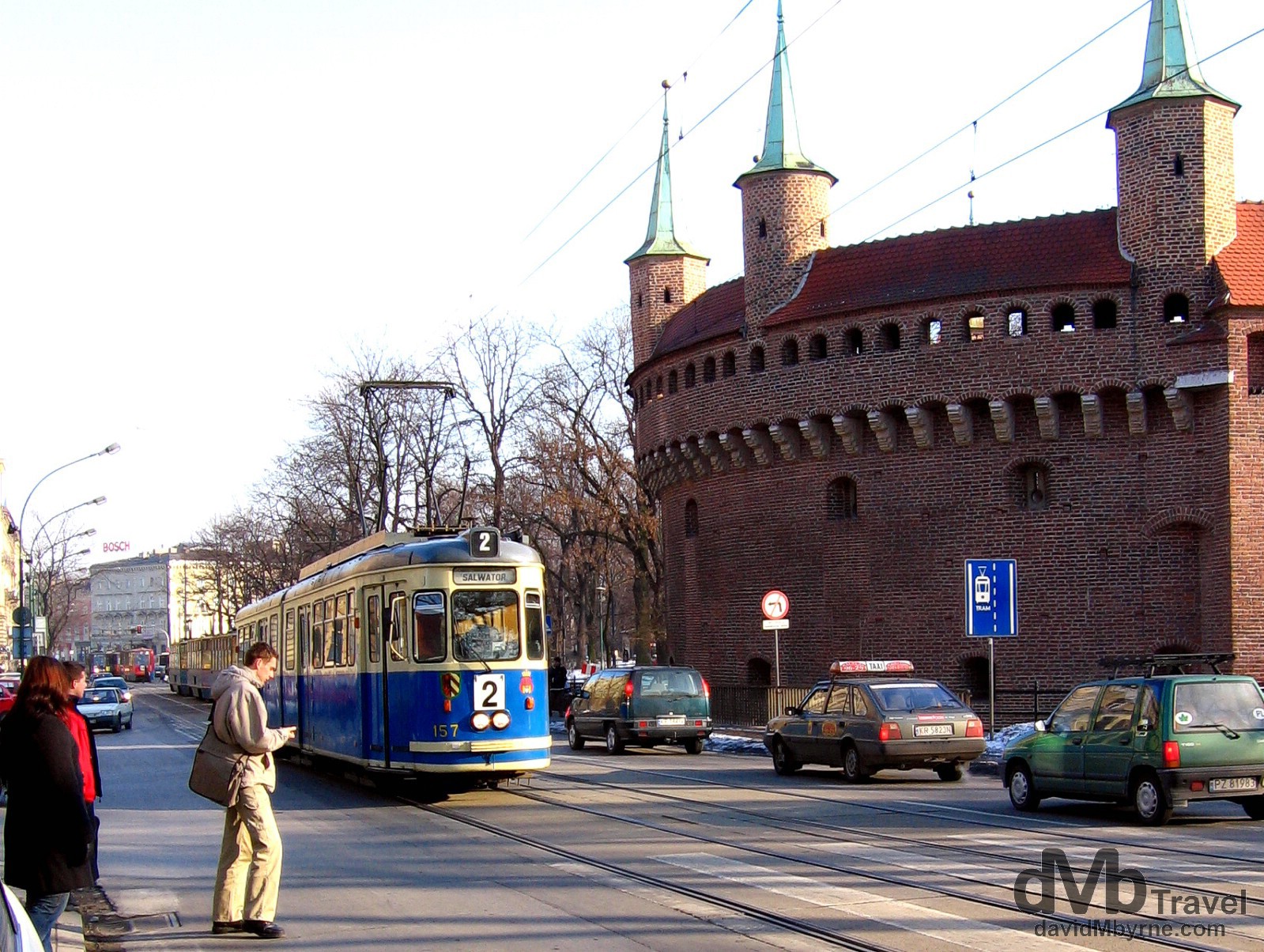 A tram plying the street fronting the circular Barbican, a defensive bastion built in 1498 as an outer defense to the city of Krakow in Poland. March 6, 2006.