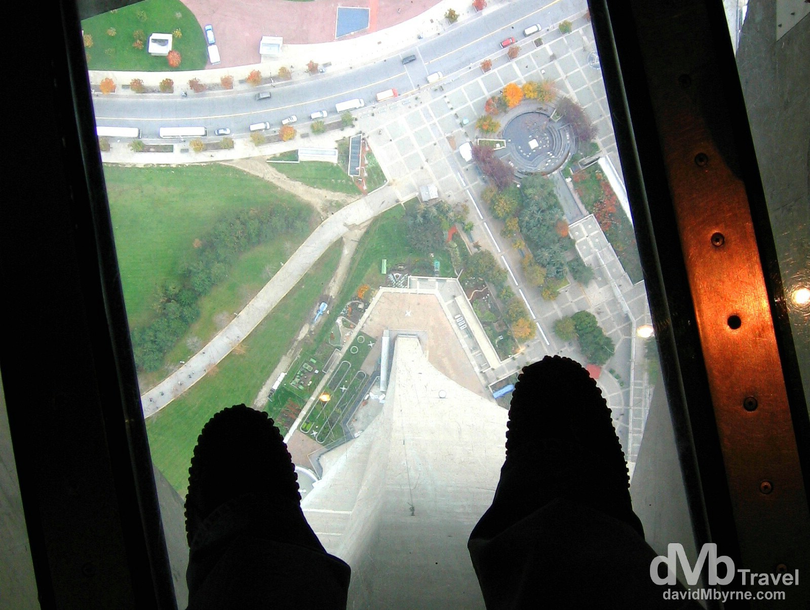 Standing on the glass floor of the viewing deck of the CN Tower in Toronto, Ontario, Canada. October 10, 2006.