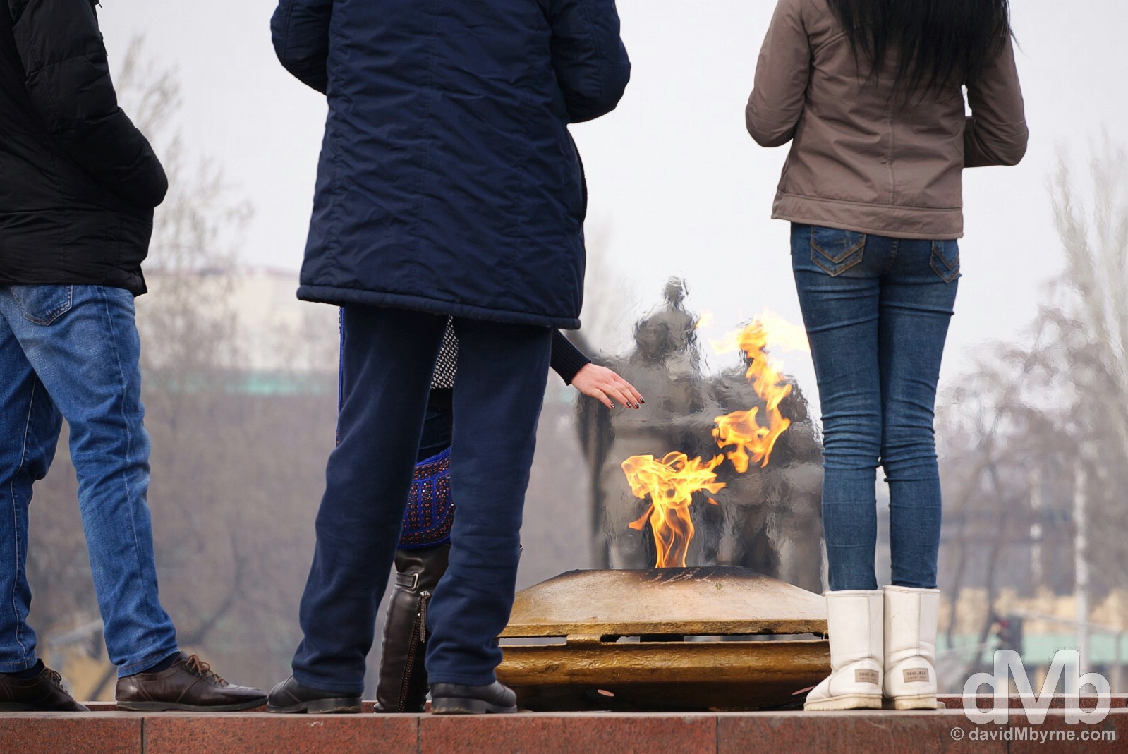 Warming up by the Eternal Flame of the War Memorial in Victory Square, Bishkek, Kyrgyzstan. February 23, 2015. 