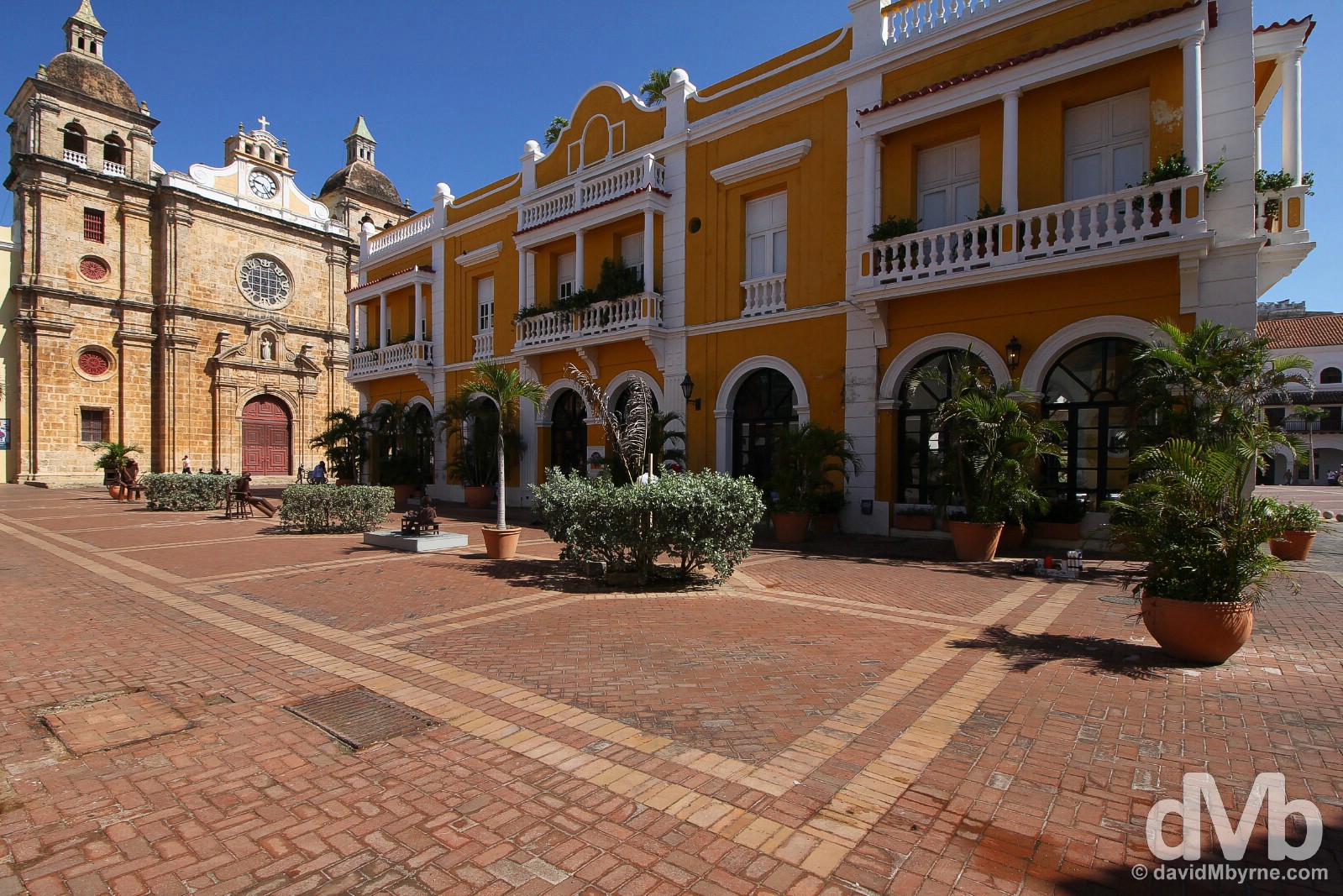 Colonial buildings, including the facade of Iglesia de San Pedro Claver, as seen from the corner of Plaza de la Aduana in Old Town Cartagena, Colombia. June 25, 2015.
