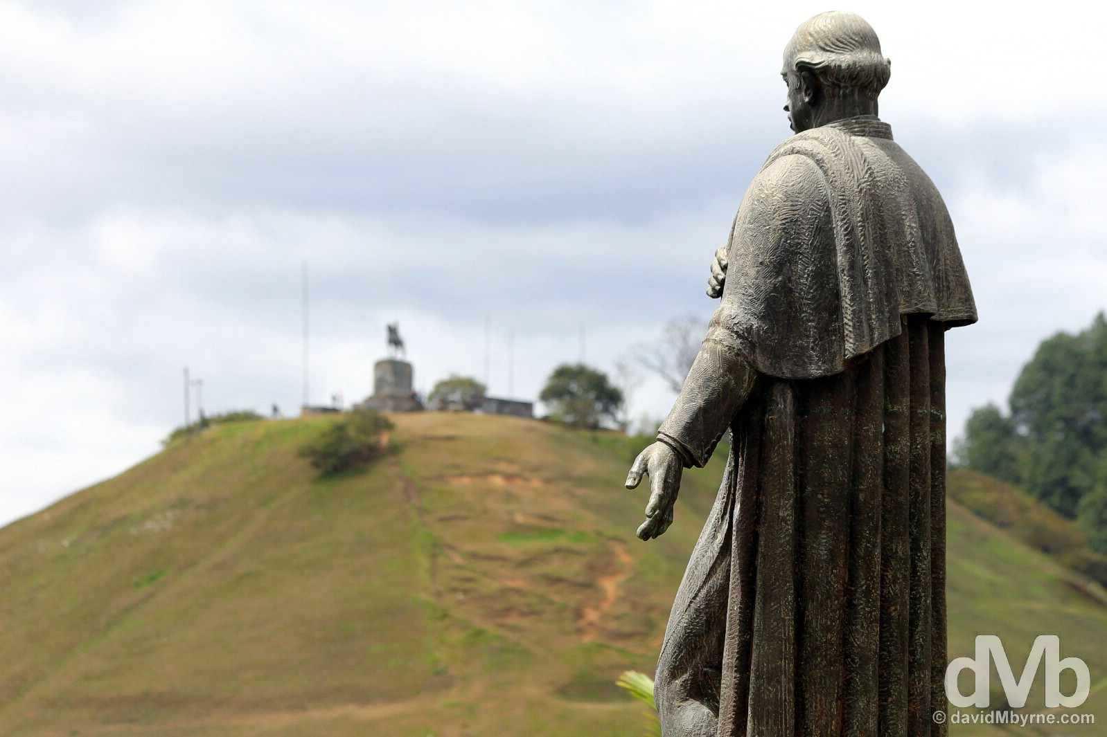 A statue of Guillermo Valencia in the grounds of the Museo Guillermo Valencia with the city lookout of El Morro de Tulcan in the distance. Popayan, Colombia. June 30, 2015.