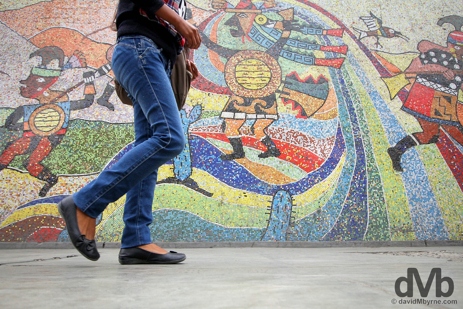 Walking past the mosaic on the walls of the Universidad Nacional de Trujillo in Trujillo, northwestern Peru. August 1, 2015.