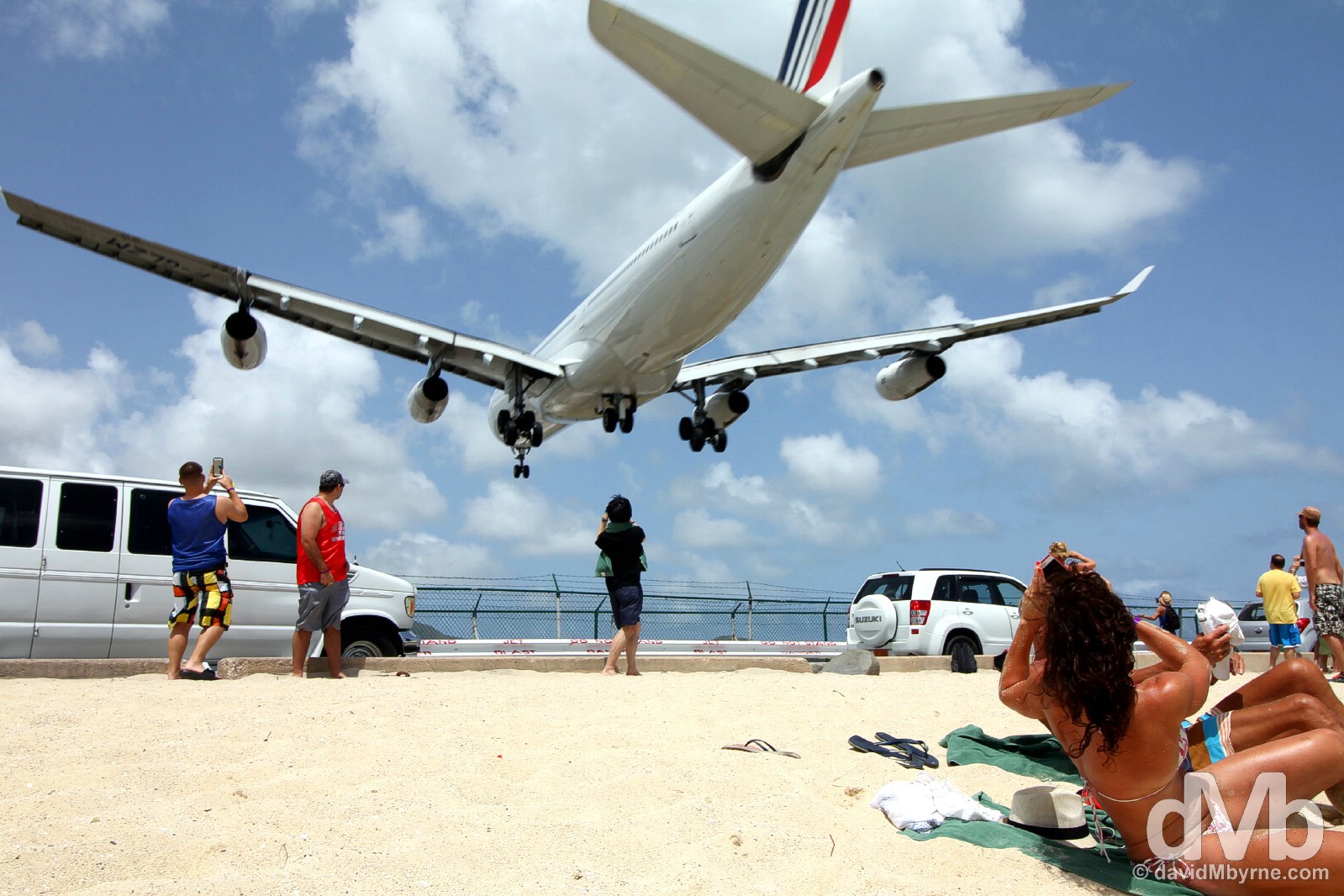 Disturbing sunbathing. An approach to Juliana Airport over the sands of Maho Beach, Sint Maarten, Lesser Antilles. June 8, 2015.