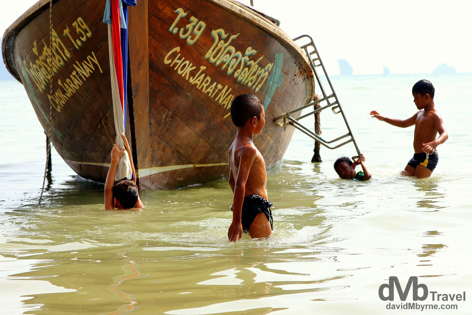 Kids Frolicking in the water off Hat Ton Sai Beach, Krabi, Thailand. March 18th 2012
