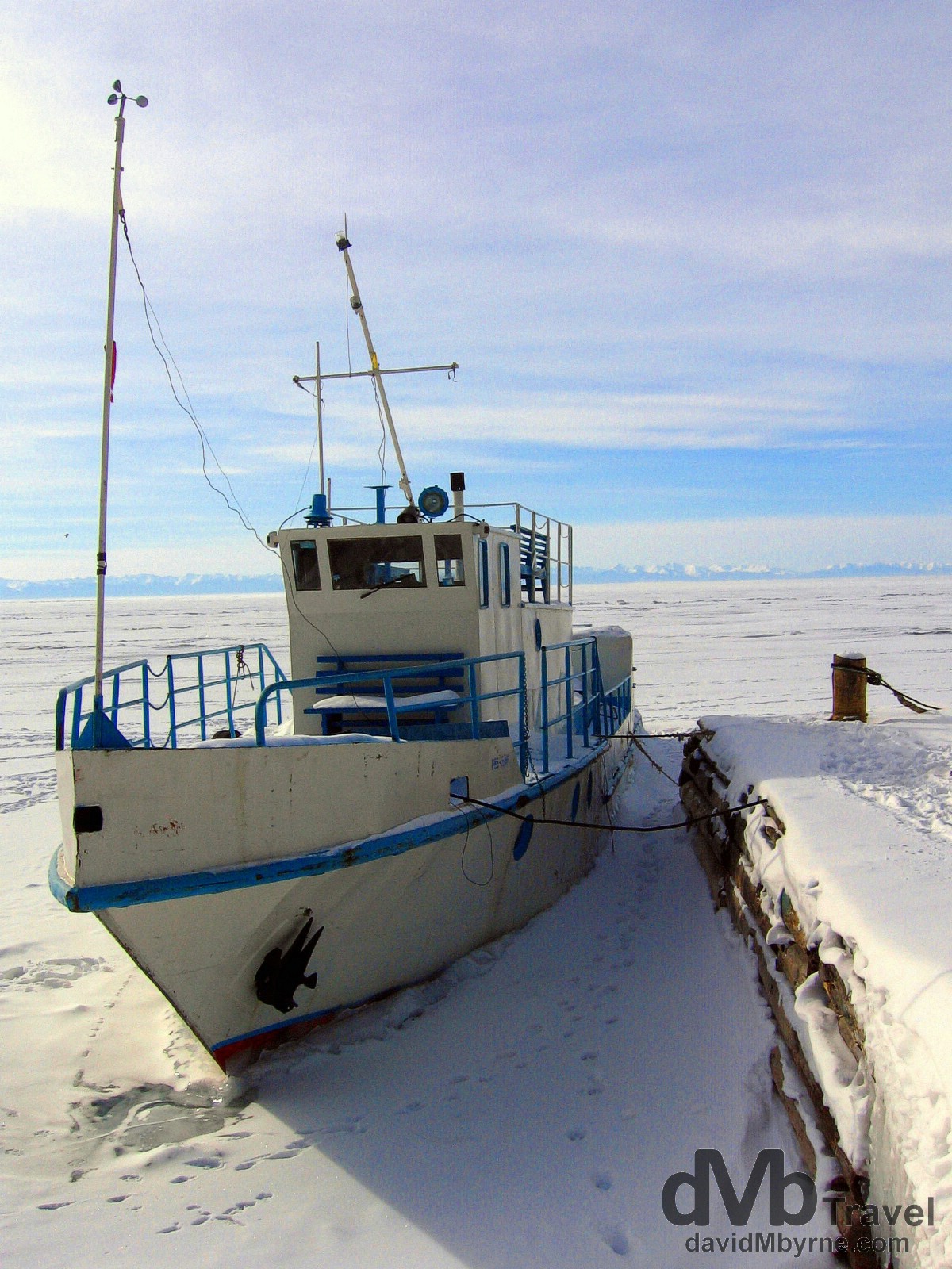 A boat waiting out the winter freeze in the fishing port of Listvyanka on the shores of Lake Baikal. Listvyanka, Siberia, Russia. February 18th, 2006.