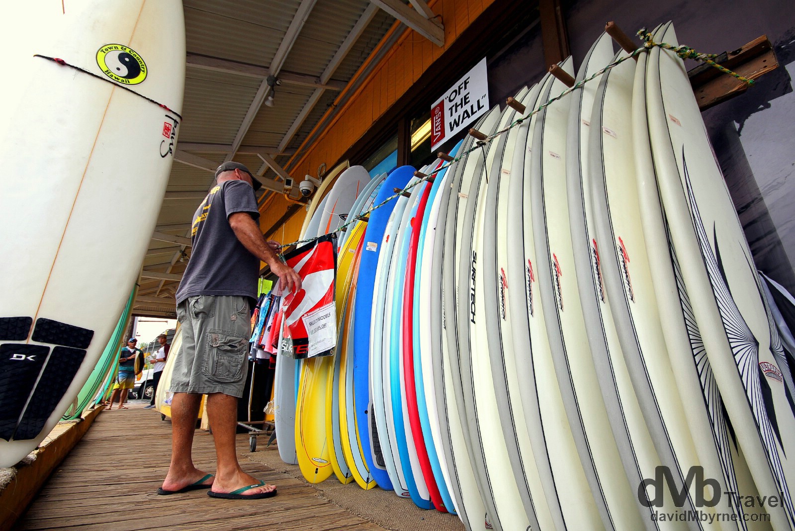 Looking at surf boards outside Surn N Sea, one of the most famous surfing shops in the world. Haleiwa, North Shore, Oahu, Hawaii. March 10th 2013.