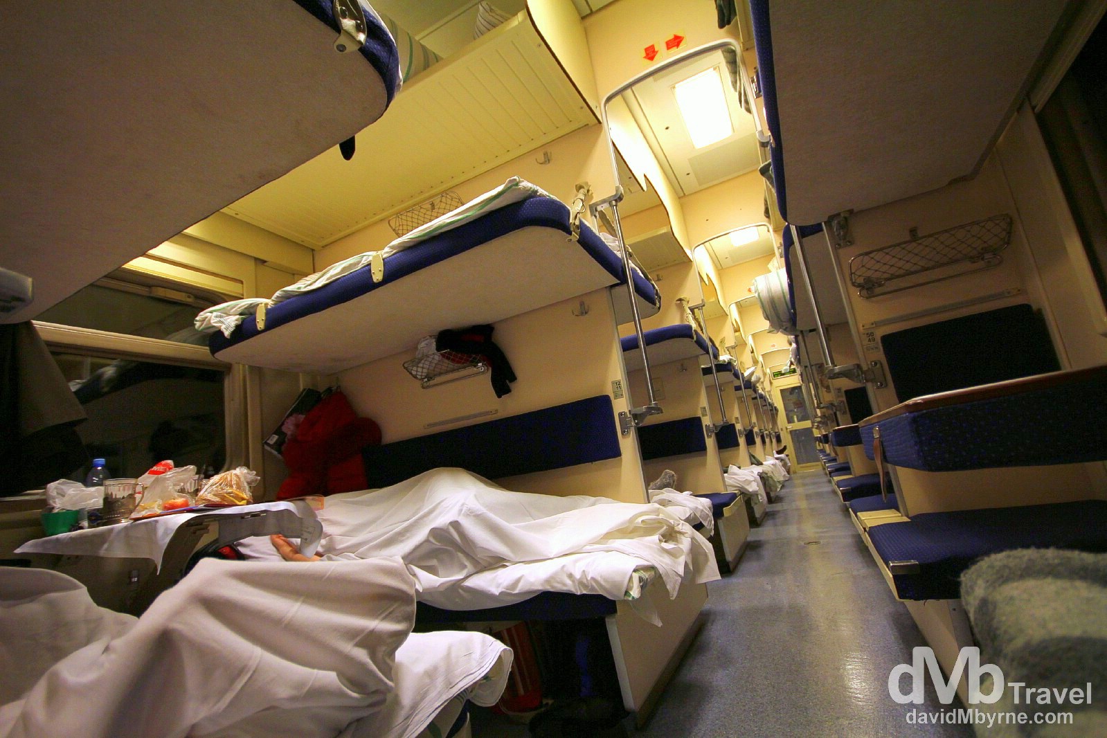 Inside the sparsely populated 3rd class/platzkart carriage number 2 of train 037. 3rd class/platzkart is an open-plan dormitory car with 54 bunks per carriage arranged in open compartments of 4 berths - 2 up/2 down - on one side (left of the picture) and 2 berths - 1 up/1 down - along the carriage wall on the other side of the aisle (right of the picture). Perfect for the budget-conscious traveller; the fare for this 48 hour+, 3,215 kilometre trip, was 3,900 roubles (€100). This carriage is new and half empty, which probably explains why I'm still all alone in my 4 berth compartment. On the train from Tomsk to Nizhny Novgorod, Russia. November 12th 2012. 