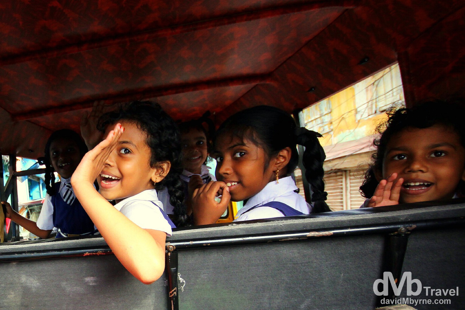 Smiles & waves out the back of a tuk tuk on Bazaar Road in Forth Cochin, Kerala, India. September 18th 2012.