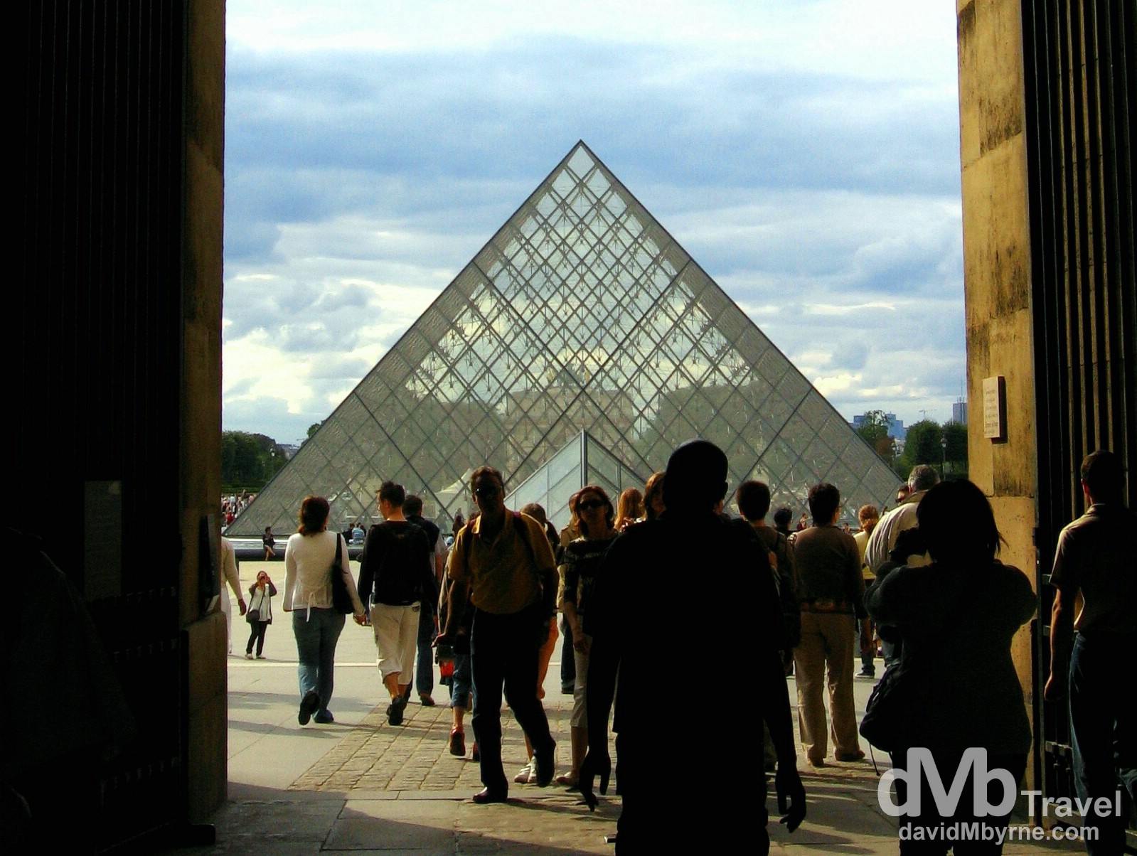 The Louvre Pyramid in the centre of the Napoleon Courtyard as seen through an opening in the Palais du Louvre (Louvre Palace), Paris, France. August 18th 2007