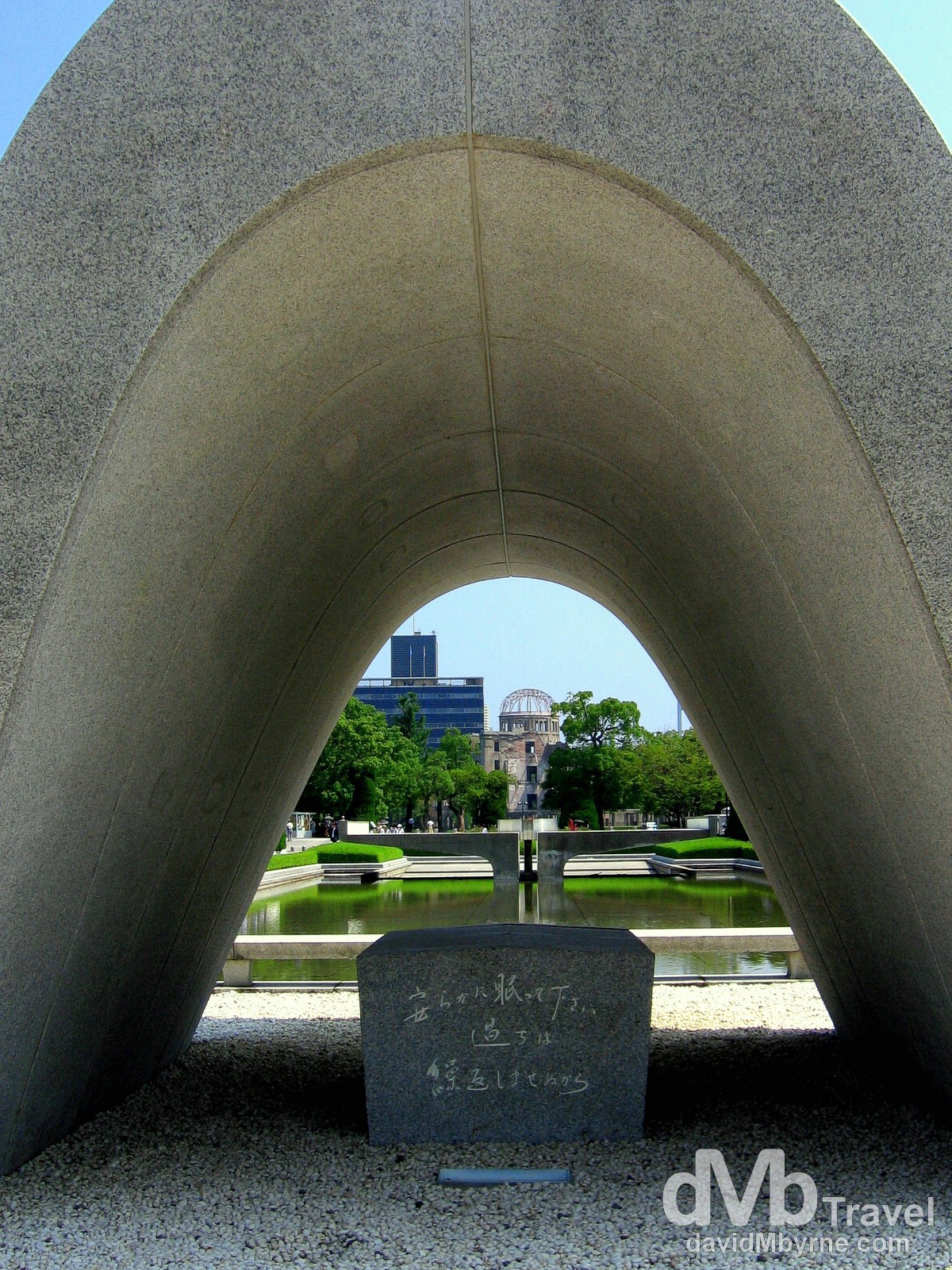 The distant A-bomb Dome as seen from under the arch of the Memorial Cenotaph in Hiroshima Peace Memorial Park, Hiroshima, Honshu, Japan. July 22nd, 2005.