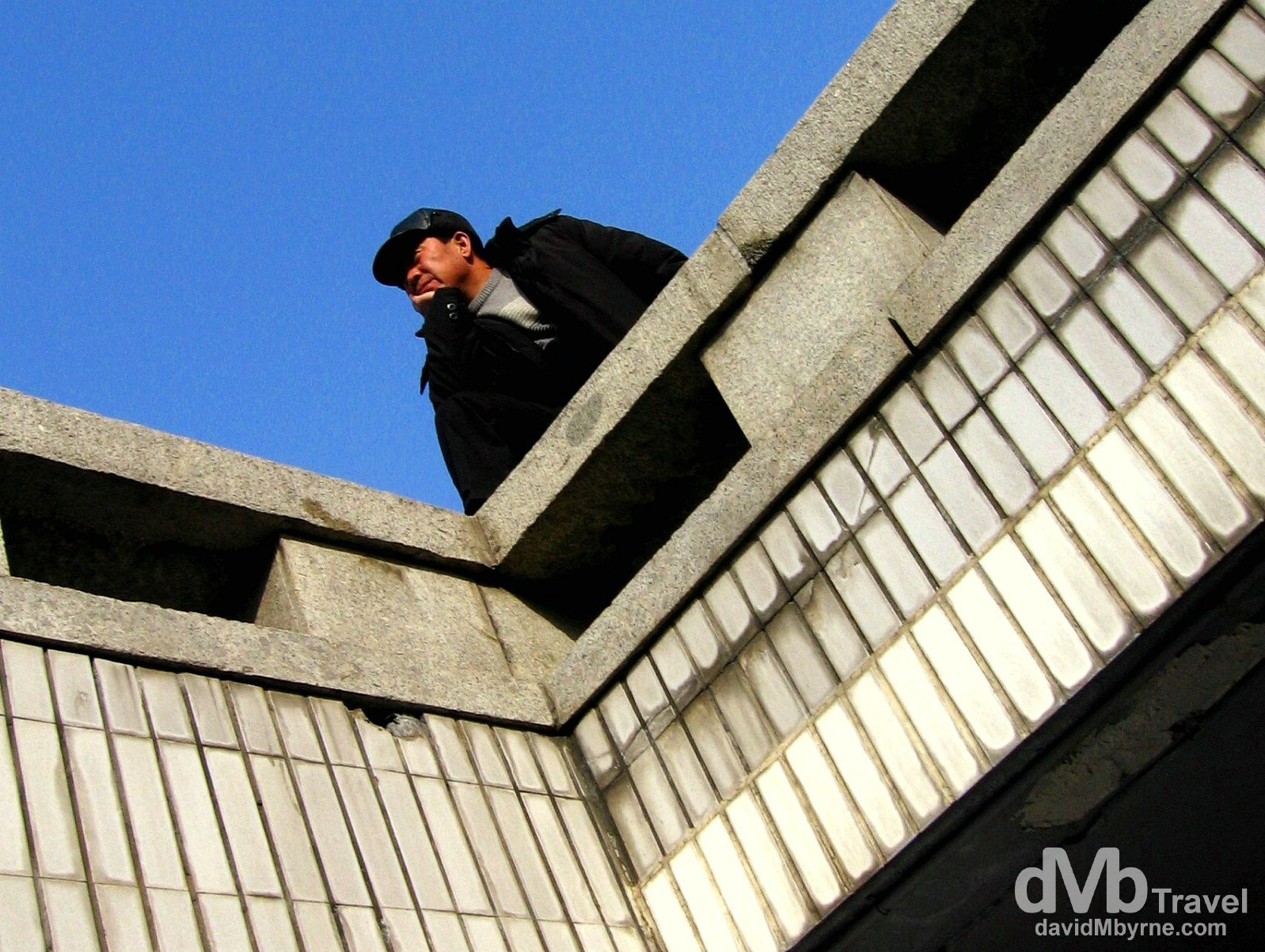 Watching life go by at an overpass in Beijing, China. February 10, 2006. 