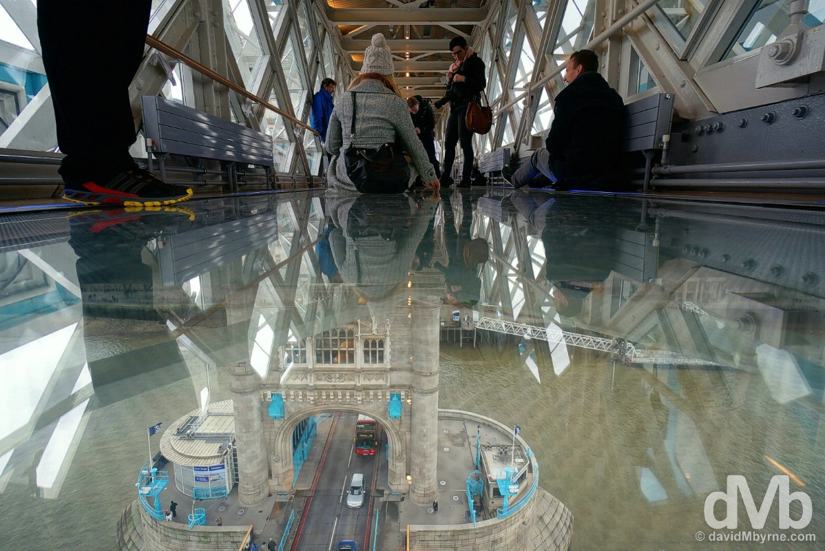 Enjoying the Glass Floor at the Tower Bridge Exhibition in the iconic Tower Bridge over the River Thames in London, England. December 12, 2014.