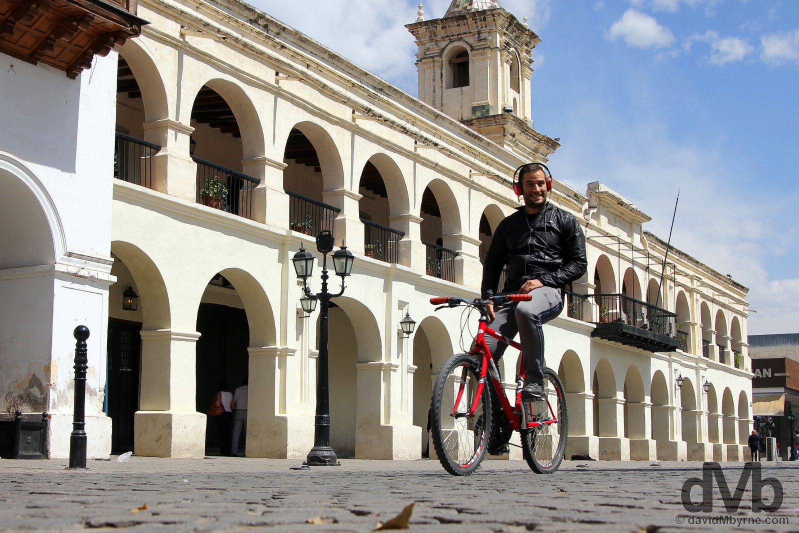Smiles cycling past the Cabildo on Plaza 9 de Julio, Salta, northern Argentina. September 7, 2015.