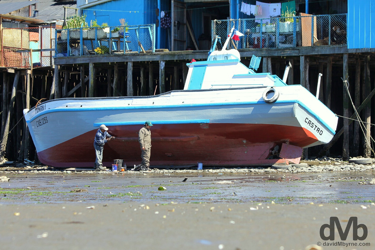 Boat maintenance at low tide in Castro, Chiloe, Chile. October 22, 2015. 