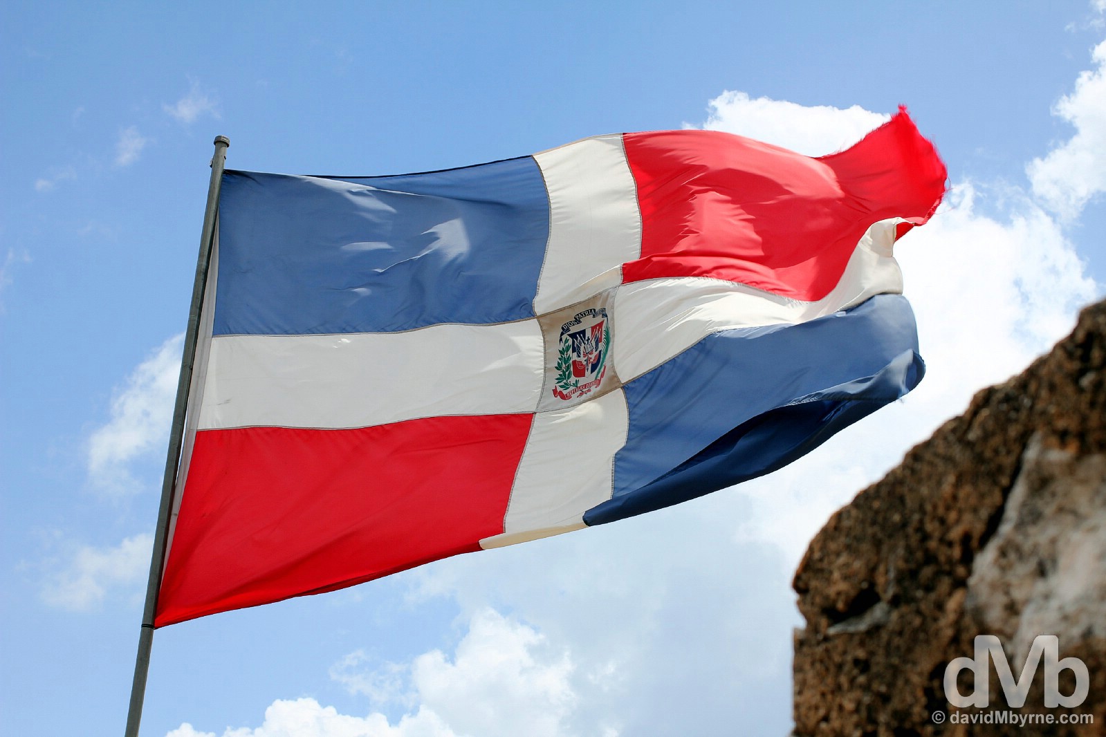 The Dominican Republic flag flying over the Torre del Homenage in Fortaleza Ozama, Santo Domingo, Dominican Republic, Hispaniola, Greater Antilles. May 26, 2015.
