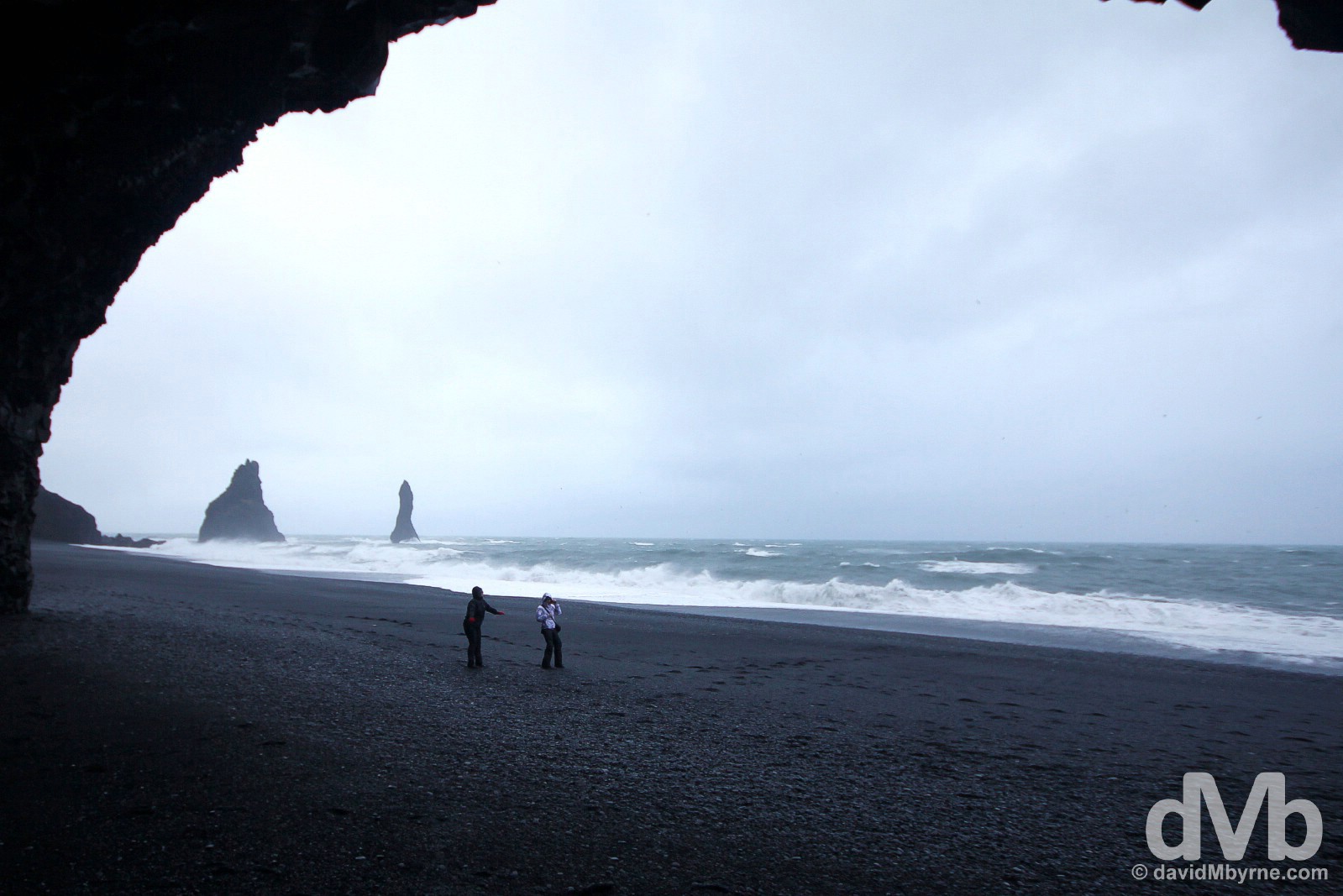 Braving the elements on the black sand beach at the base of the hill Reynisfjall in Myrdalur, southern Iceland. December 5, 2012.